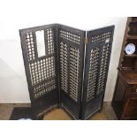 An Eastern carved hardwood three panel folding screen