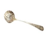A George III silver sauce ladle, having fluted bowl, bearing family crest, London 1782