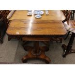 A William IV rosewood card table, the fold-over swivel top raised on a barrel column and quadruple