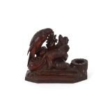 A 19th Century carved Black Forest desk stand, surmounted by an eagle perched on rocks and chamois