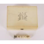An ivory box, having monogrammed hinged lid, contents to include an ivory handled seal etc.