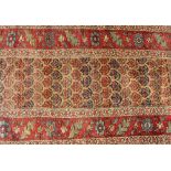 An Eastern runner, with Boteh decoration within stylised floral borders, 406cm x 95cm