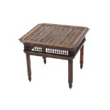 A small ethnic style carved hardwood occasional table, the canted corner top with stylised