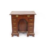 A George III mahogany knee-hole desk, fitted two short frieze drawers above a recessed cupboard,