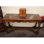 A walnut William and Mary style hall table, having shaped frieze, raised on baluster turned supports