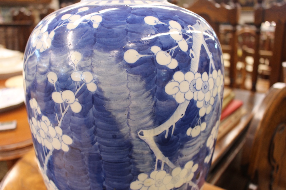 A large Chinese blue and white vase and cover, with Prunus decoration, restored, the lid  AF, 44cm - Image 7 of 8