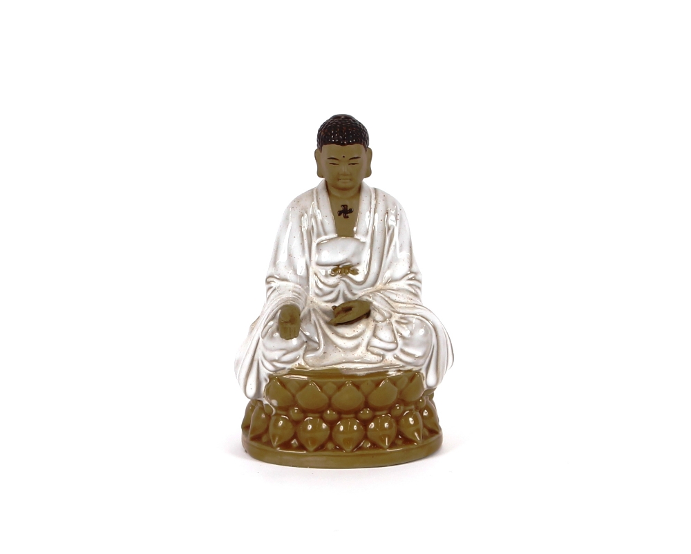 A glazed pottery figure of a seated Buddha, 16cm high