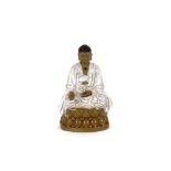 A glazed pottery figure of a seated Buddha, 16cm high