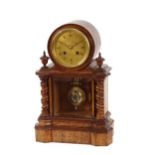 A late Victorian golden oak cased mantel clock, having circular engraved brass Roman numeral dial,