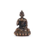 A copper figure, of a seated Buddha, 26cm high