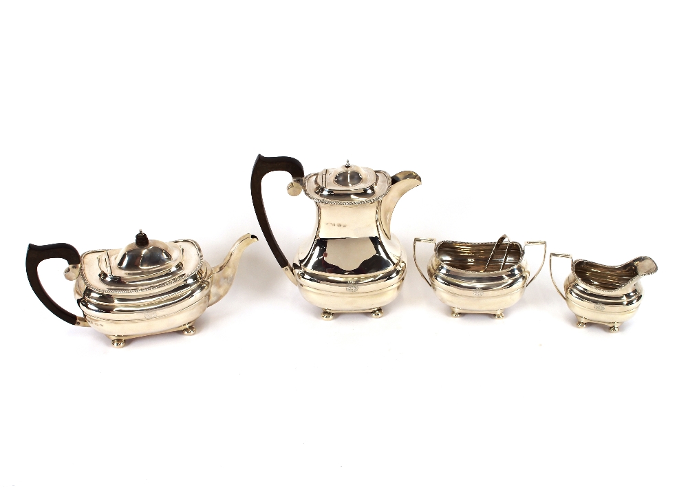 A silver four piece tea set, of baluster form, having gadroon borders, raised on ball feet,