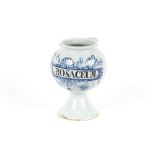 An 18th Century Delft wet drug jar, inscribed MEL:ROSACEUM:, blue floral cherub and shell