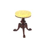 A Victorian walnut revolving piano stool, floral brocade upholstered seat on baluster column and