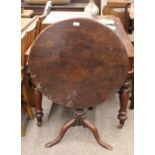 A Georgian mahogany circular snap top tea table, raised on turned baluster column and tripod base,