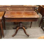 A Regency mahogany card table, the fold over swivel top raised on ring turned baluster column with