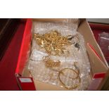 A box of various yellow metal necklaces and bracel