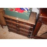 An antique oak chest fitted four long drawers for