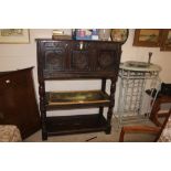 An antique oak panelled cupboard with drop front f