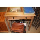 A stripped pine single drawer side table