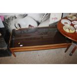 A teak and glass topped two tier coffee table