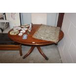 A reproduction yew oval topped coffee table