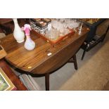 An Ercol drop leaf kitchen table and a set of four