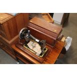 A Singer hand sewing machine in fitted case