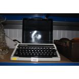 A Silver Reed travelling typewriter