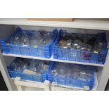 Four plastic crates of various glassware