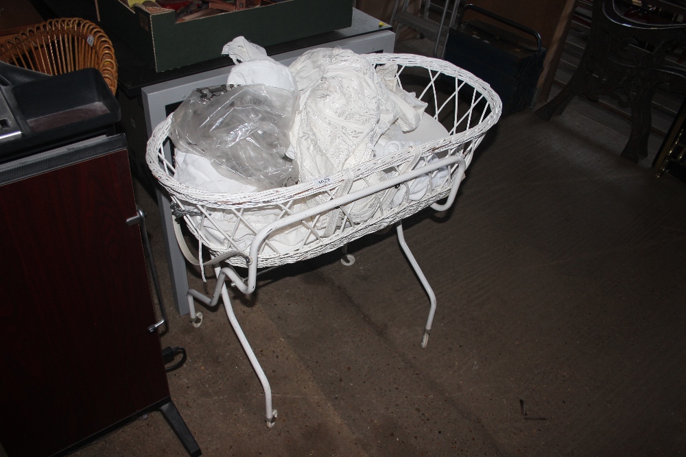 A metal and wicker crib and contents