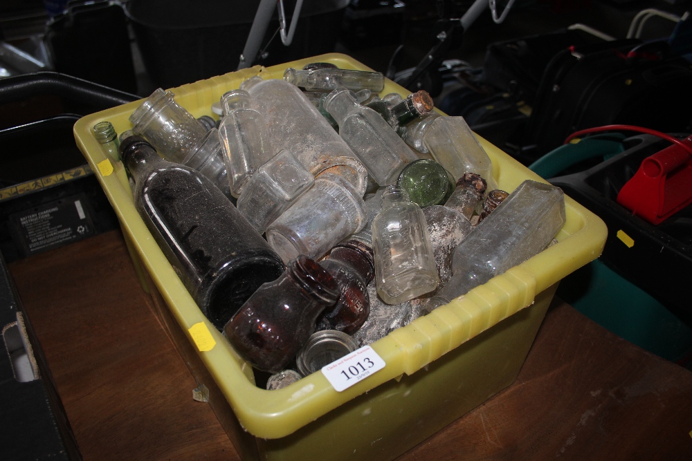 A box of various old glass bottles