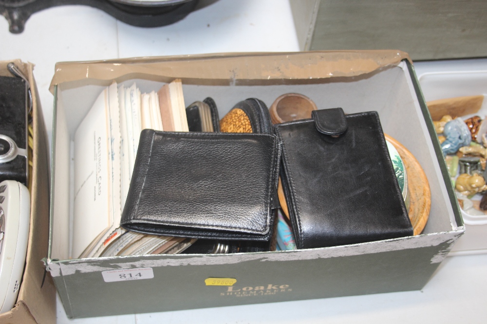 A box containing various wallets; postcards etc.