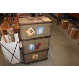 A wooden bound canvas travelling trunk bearing labe