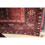 An approx. 6'7" x 4'8" red patterned rug