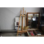An artist's easel and various as new canvases etc
