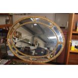 A gilt framed oval wall mirror