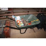 A plastic wheelbarrow and contents of various gard