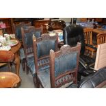 A set of four late Victorian oak dining chairs