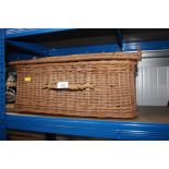 A wicker picnic basket and contents