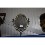A brass swing frame toilet mirror