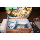 A wicker picnic hamper and contents