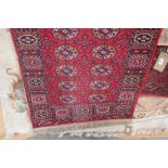An approx. 10'10" x 2'8" red patterned rug