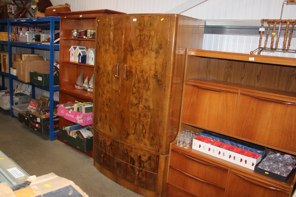 A walnut veneered bow front wardrobe fitted two dr