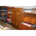 A walnut veneered bow front wardrobe fitted two dr