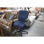 A blue upholstered swivel office chair