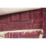 An approx. 5' x 2'10" red patterned rug