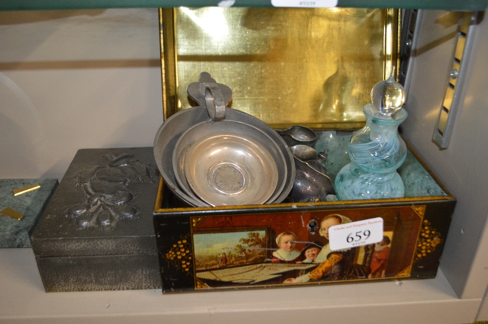 A tin containing an Art Glass scent bottle; a bras