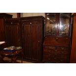 A stained pine single door wardrobe