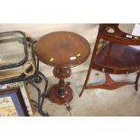 A Victorian mahogany circular topped table raised