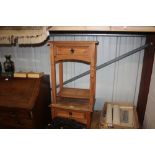 A pair of pine single drawer two tier bedside tabl